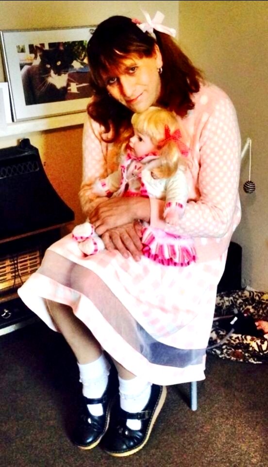 A older pic of me wearing my girls top and skirt holding my Dollie