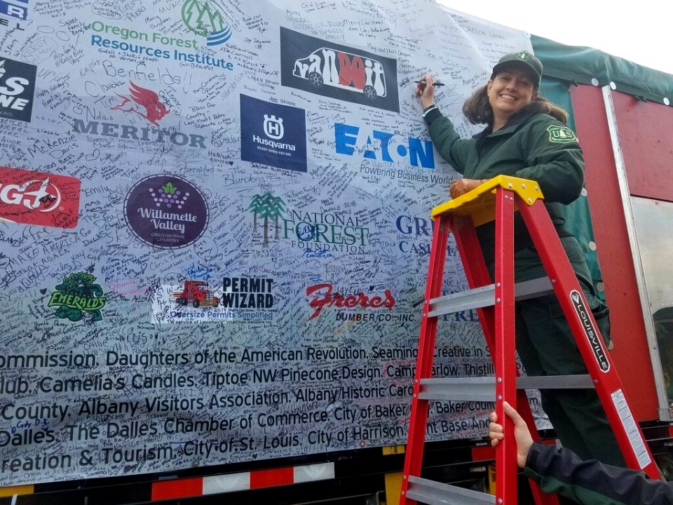 Forest Service Public Affairs Officer signs "The People's Tree" as it passes through The Dalles. for