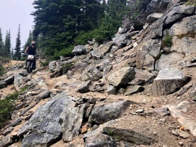 TrailCrewpersonOnMotorcycleOnTrail-OkaWenNFbyMasonSchuurUSFSJune2019
