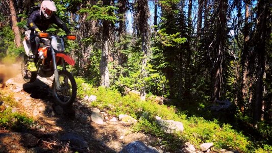 Motorcycle-FS TrailCrewPersonOnMotorcycleOkaWenNFbyMasonSchuurUSFS-July2019