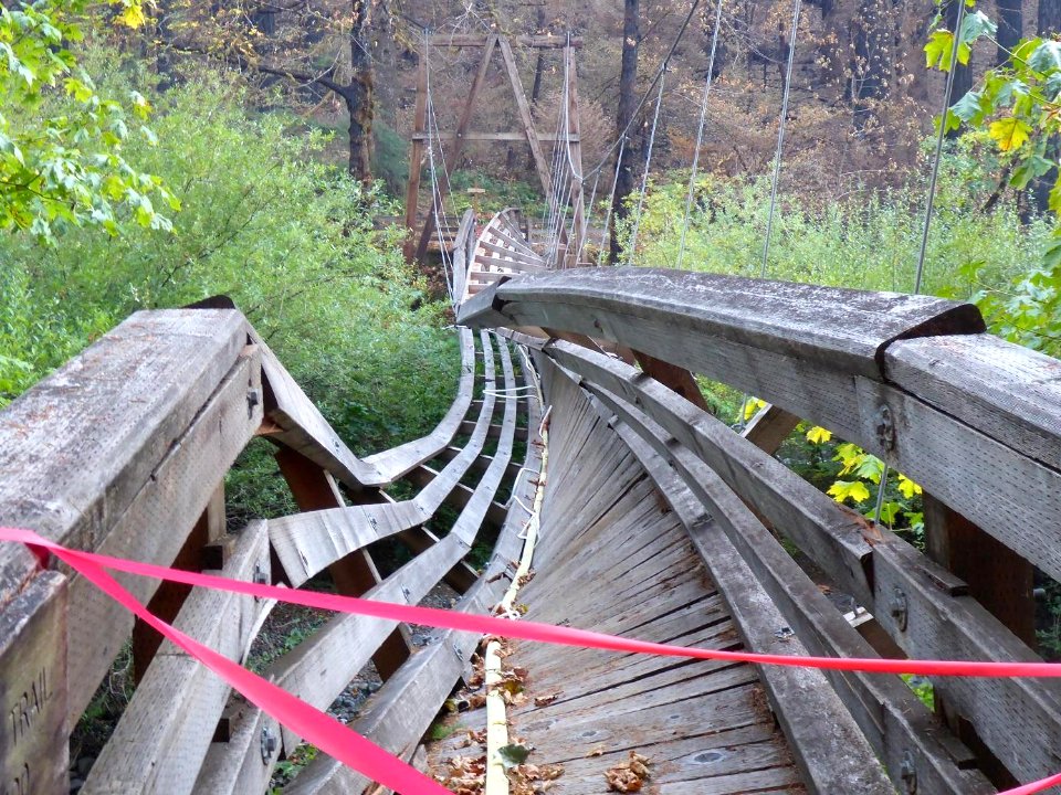 A view across the Eagle Creek suspension bridge after a support cable pulled free.