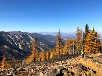 Motorcycle-onTrailWithGoldenLarchMtStuartInDistance(2)OkaWenNFbyMasonSchuurUSFS-Oct2018