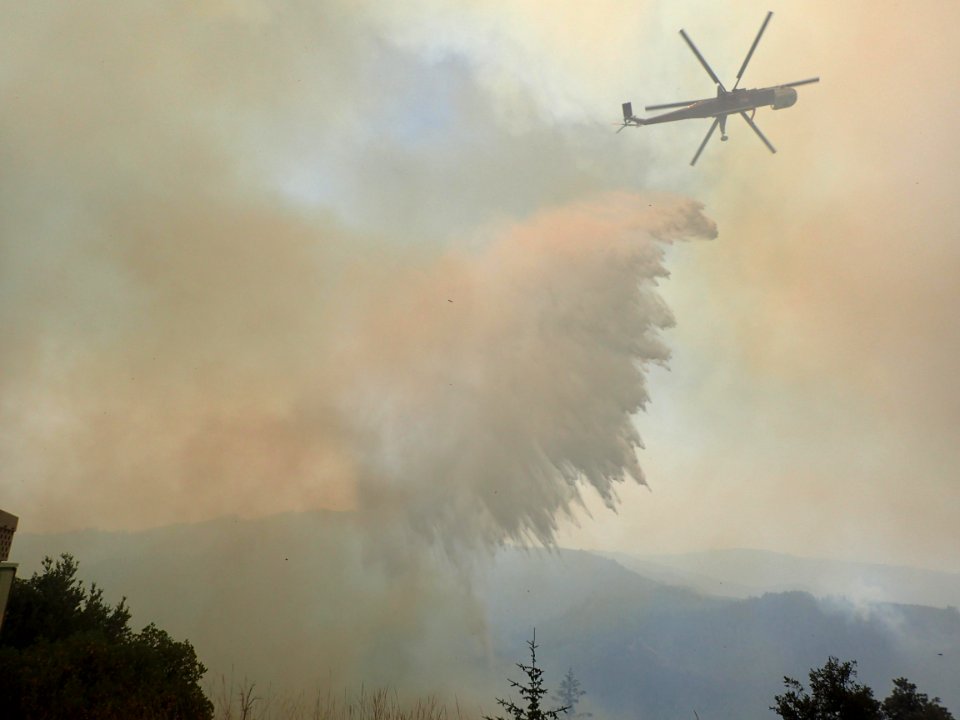 Type 1 (Heavy) helicopter completing a water drop on a Sugar Pine Fire spot July 28, 2018