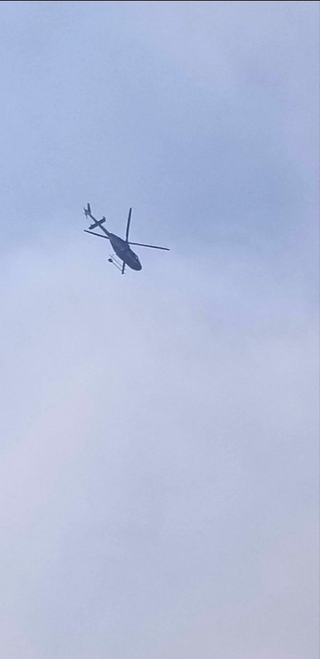 A helicopter is seen flying over the Canyon 66 Prescribed fire photo