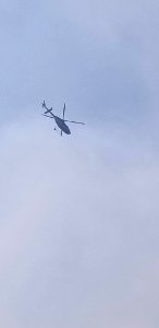 A helicopter is seen flying over the Canyon 66 Prescribed fire