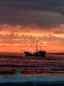 Day 029 pirate ship sailing off in the sunset.
