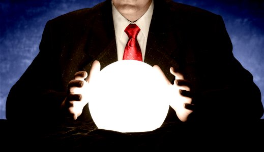 Businessman Consulting Glowing Crystal Ball photo