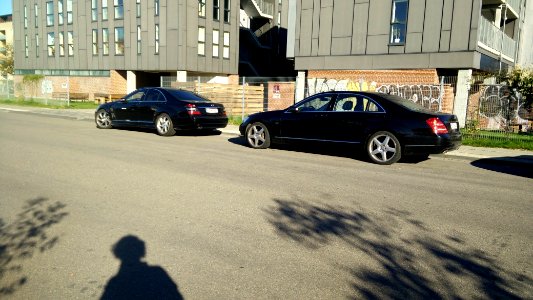 Two W221 S-Class Benz's in black. Usually you would see something like this near a ministry or an embassy. But these two were spotted in a fairly bad neighborhood of Copenhagen. The one on the left has AMG vents in the front fenders and aftermarket wheels photo