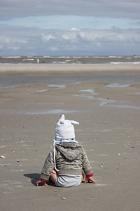 Sand baby sitting photo