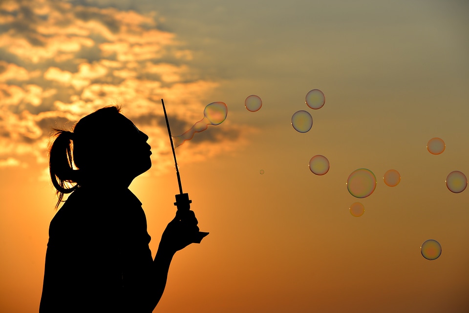 Silhouette blowing bubbles blowing photo