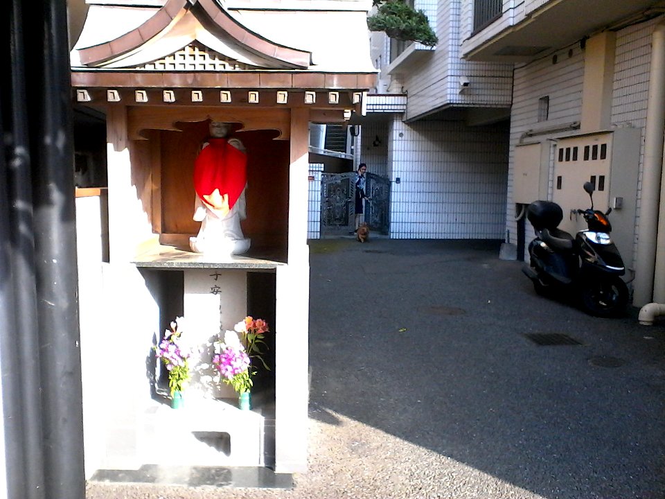 Little shrine at the bottom of an apartment building