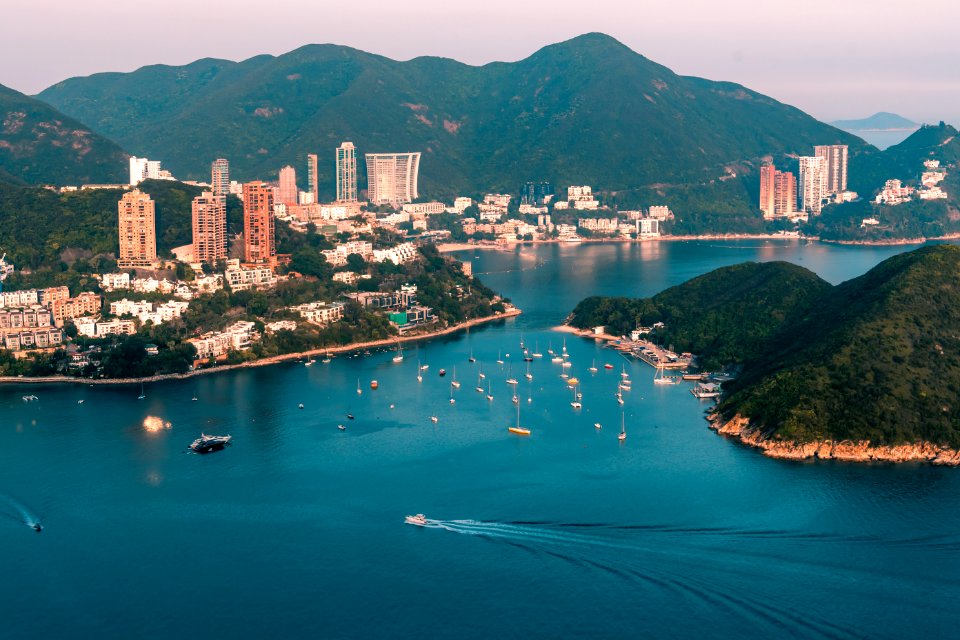 View of clouds, boats, Middle islands, buildings in seaside in Deep Water Bay, Hong Kong seen form brick hill (nam long shan)
