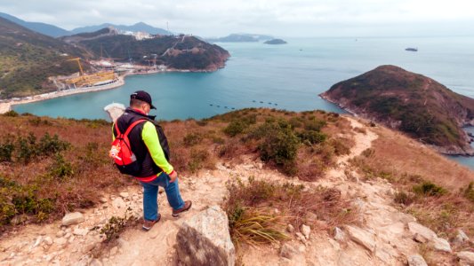The man is hiking on the hill at Yuk Kwai Shan (Cinnamon Mountain) located in Ap Lei Chau, Hong Kong photo