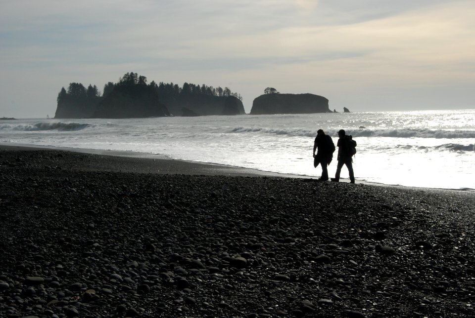 visitors hiking silhouette rialto beach coast c bubar march 06-2015