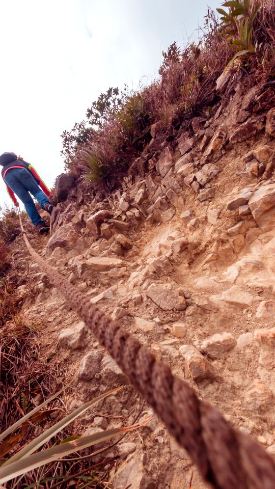 The man is hiking on the hill at Yuk Kwai Shan (Cinnamon Mountain) located in Ap Lei Chau, Hong Kong photo