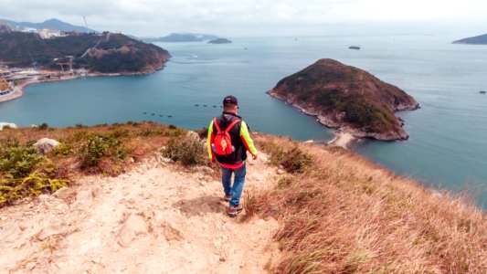 The man is hiking on the hill at Yuk Kwai Shan (Cinnamon Mountain) located in Ap Lei Chau, Hong Kong photo