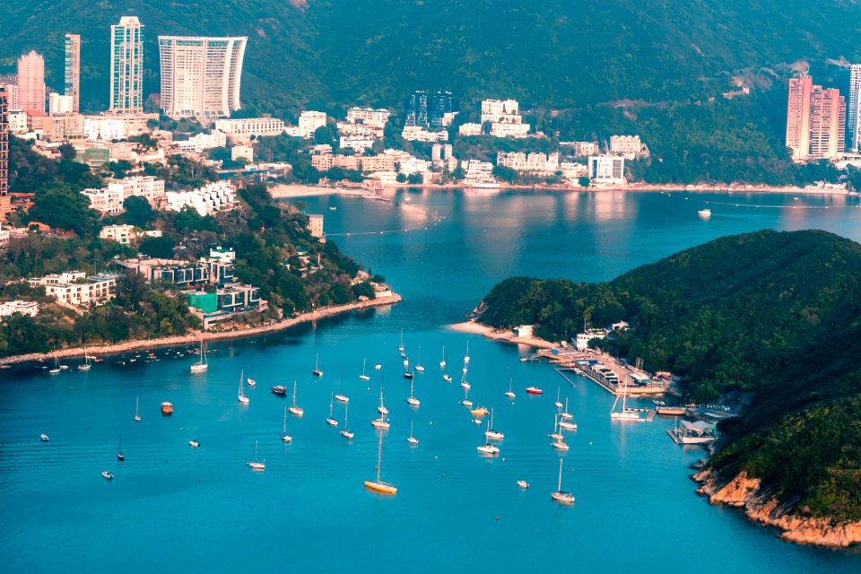View of clouds, boats, Middle islands, buildings in seaside in Deep Water Bay, Hong Kong seen form brick hill (nam long shan)