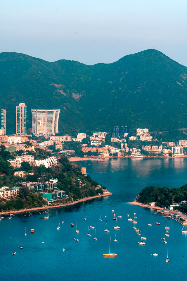 View of clouds, boats, Middle islands, buildings in seaside in Deep Water Bay, Hong Kong seen form brick hill (nam long shan)