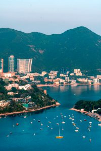 View of clouds, boats, Middle islands, buildings in seaside in Deep Water Bay, Hong Kong seen form brick hill (nam long shan)