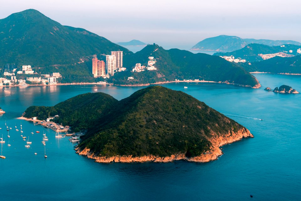 View of clouds, boats, Middle islands, buildings in seaside in Deep Water Bay, Hong Kong seen form brick hill (nam long shan)