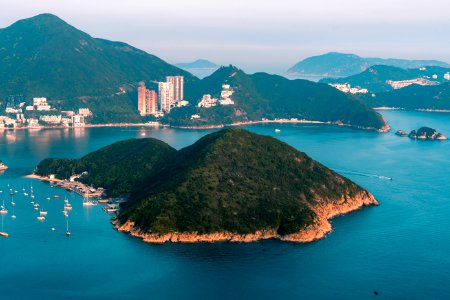 View of clouds, boats, Middle islands, buildings in seaside in Deep Water Bay, Hong Kong seen form brick hill (nam long shan)