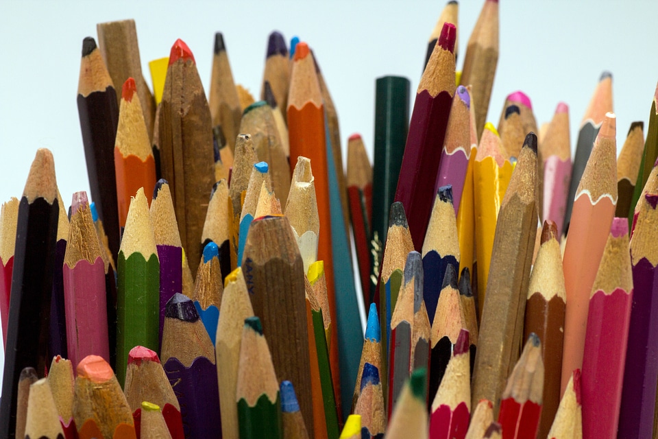 Close up different colored crayons draw