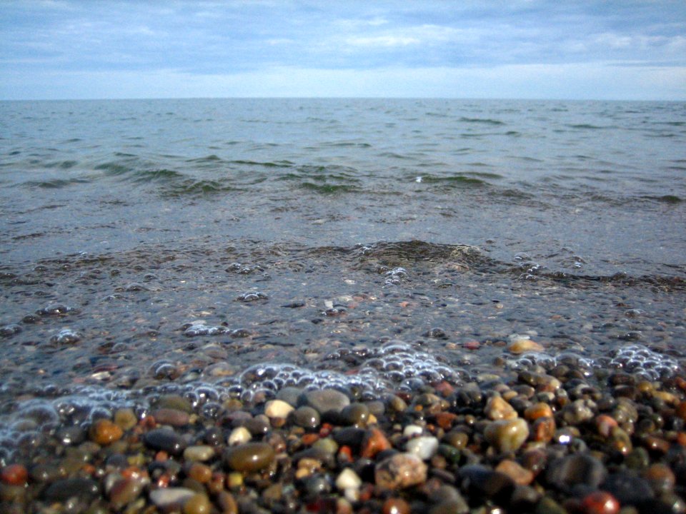 Pebbles, water, sky.