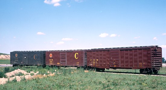 Chicago Great Western Cabooses, Box Cars, and More -- 4 Photos photo