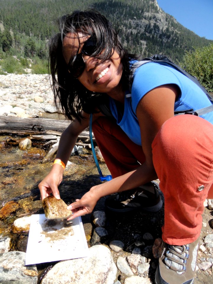 Young girl holding a rock near a stream in Rocky Mountain National Park. NPS photo.