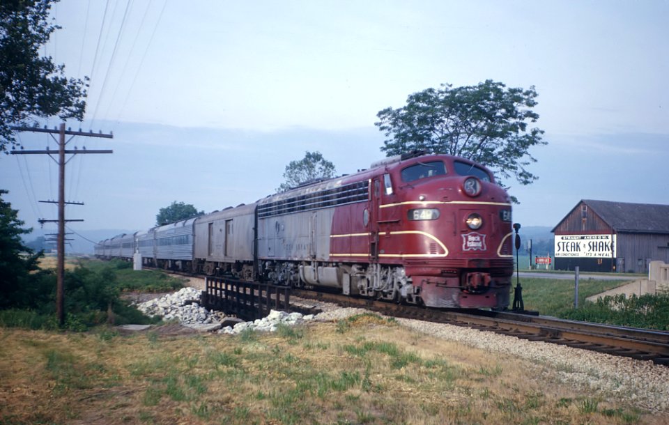 CRI&P E8A 649 with Train 12, the Peoria Rocket approaching Mossville, IL (just outside Peoria) in the early morning sun in June 1963