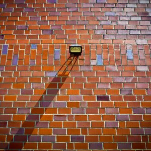 Brick wall lamp shadow photo