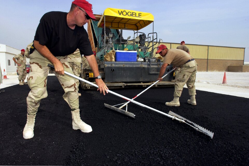 Workers labor pavement