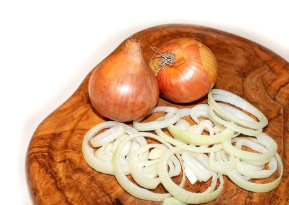 Vegetables onions in slices onions on board photo