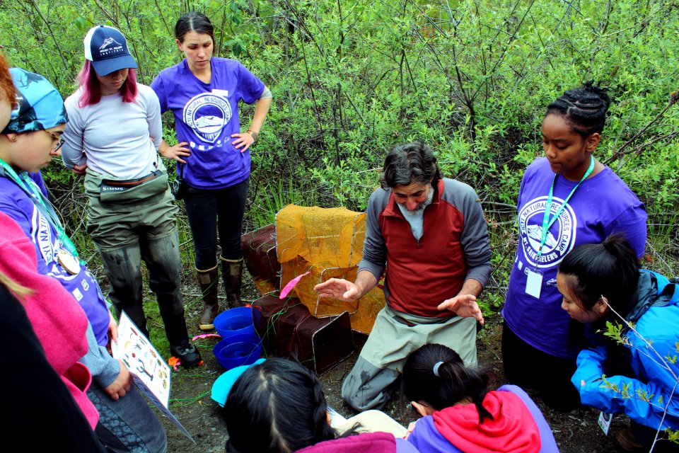 U.S. Forest Service Researcher Chrales Cristafulli presenting the aquatic creatures of the ponds at Mount St. Helens