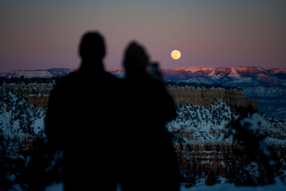 Couple watches the moonrise
