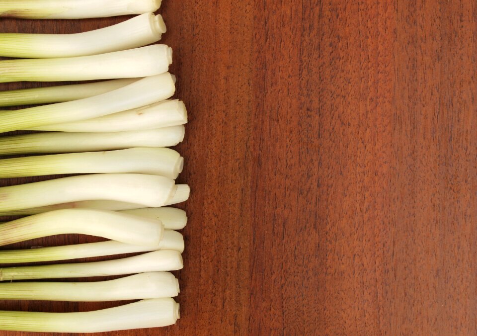 On a wooden background background feathers onion
