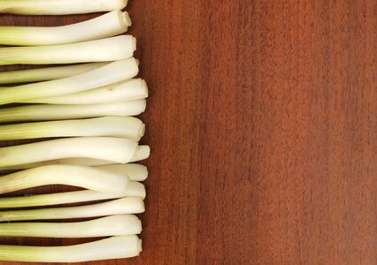 On a wooden background background feathers onion