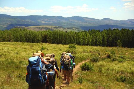 Backpacking grass fields trees photo