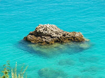 Blue turquoise the rock in the water photo