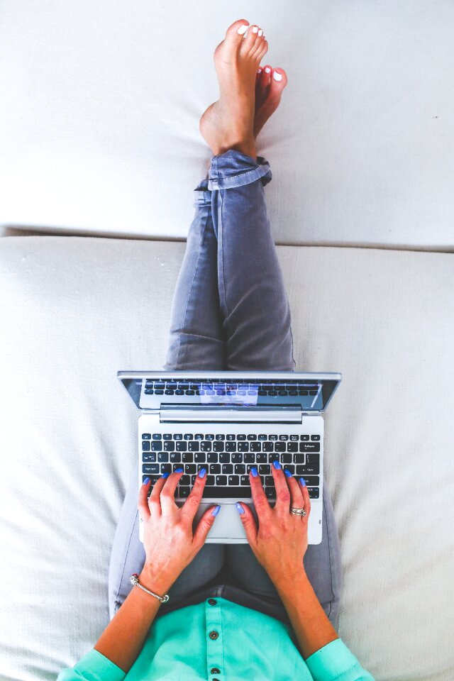 Lying typing laptop