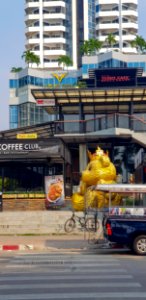 Highly Unlikely Golden Teddy Bear Sitting on a Street