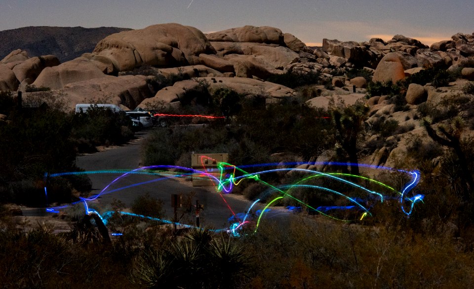Campers toss a light-up disc back and forth in Jumbo Rocks Campground
