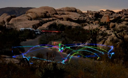 Campers toss a light-up disc back and forth in Jumbo Rocks Campground