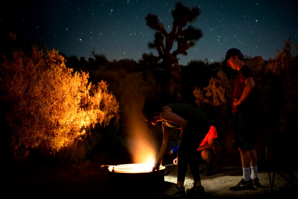 Standing around a campfire in Jumbo Rocks Campground