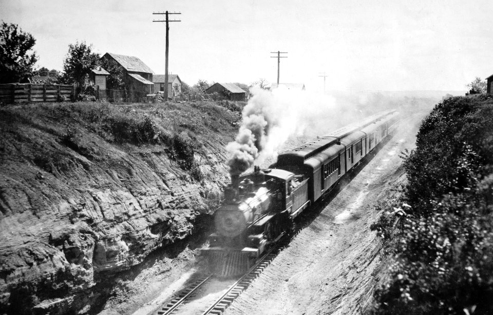Vintage 4-4-0 working hard with 6 cars in a cut.