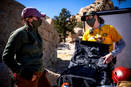 Joshua Tree Search and Rescue team members discussing pack items
