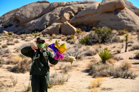 Park ranger holding balloons