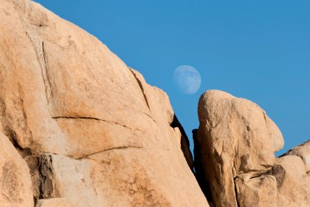 Moon rising over boulders photo