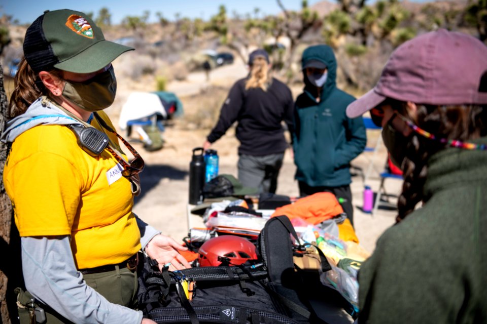 Joshua Tree Search and Rescue team members discussing pack items photo