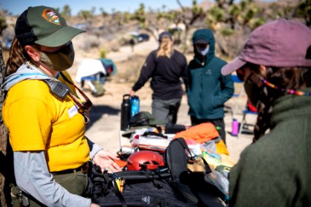 Joshua Tree Search and Rescue team members discussing pack items photo